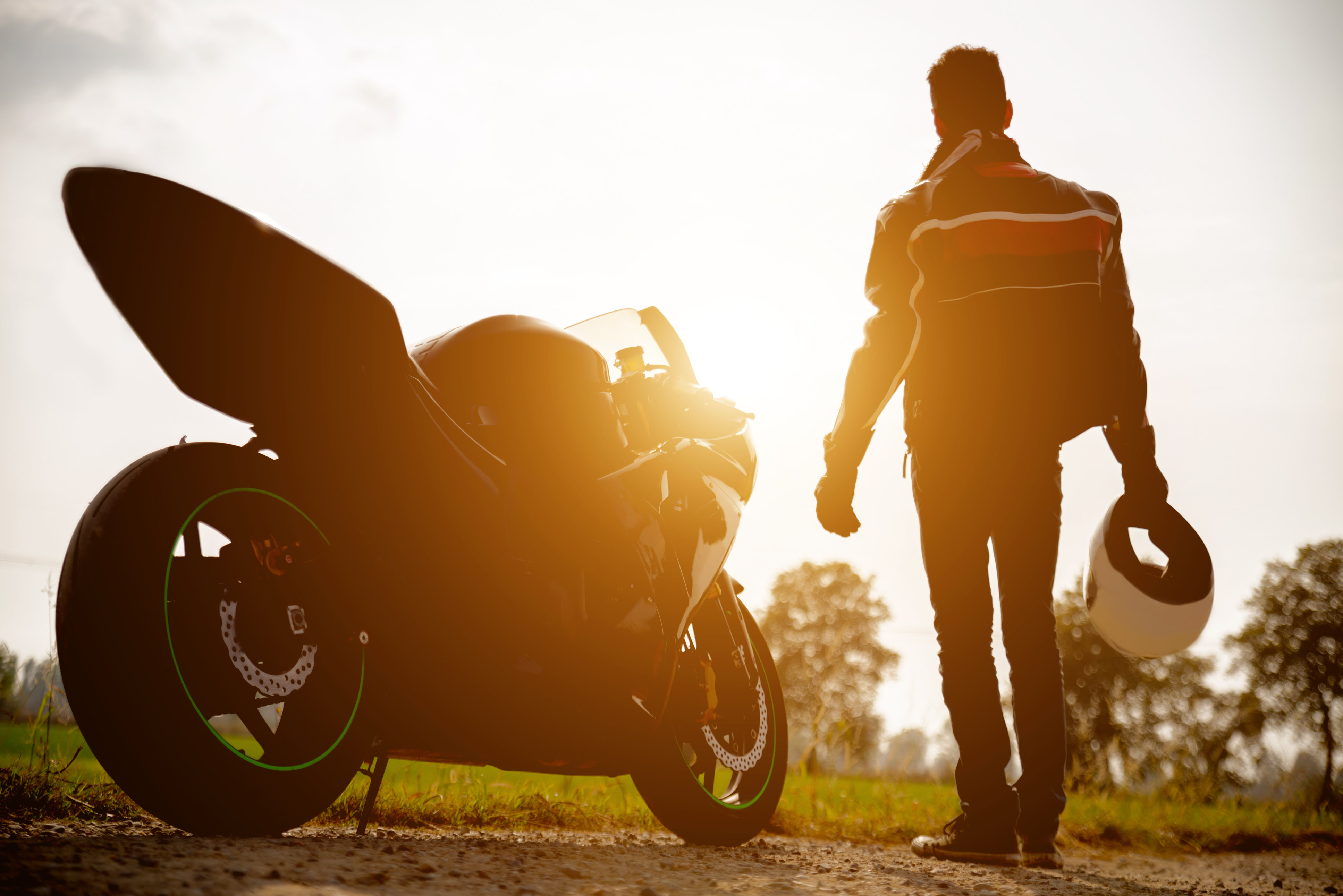 a man stood next to a motorbike - Motorbike tracker